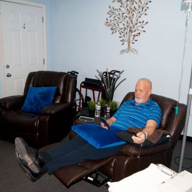 Patient sitting in chair receiving IV therapy